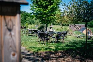 a group of tables and chairs in the grass at Penzion Na Červeném Potoce in Králíky