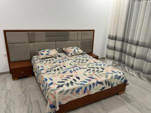 a bedroom with a bed with a bedspread and pillows at Dar Selima Hammamet in Hammamet +76 photos
