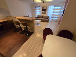 a living room with a table and chairs and a couch at Apartment Vodni with parking in Brno