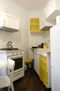 a kitchen with white cabinets and a stove at Borgo e Lago in Anguillara Sabazia