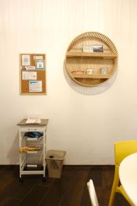 a wicker basket hanging on a wall with a table at Borgo e Lago in Anguillara Sabazia