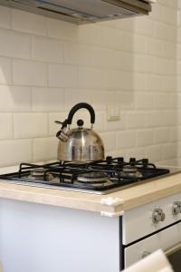 a tea kettle sitting on top of a stove at Borgo e Lago in Anguillara Sabazia +33 photos