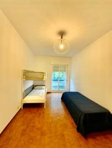 a bedroom with a bed and a chandelier at Deiva Marina Home a due passi dalle 5 terre in Deiva Marina