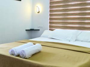 a bedroom with two rolled towels on a bed at Marari Anns Casa Beach Homestay in Mararikulam
