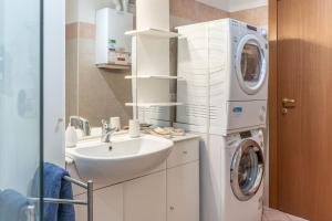 a bathroom with a sink and a washing machine at FREE PARKING-HISTORICAL LUXURY PALACE- CITY VIEW-Free Wifi&Pet Friendly in Trento