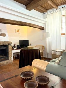 a living room with a couch and a fireplace at Maruan Heaven in Marvão