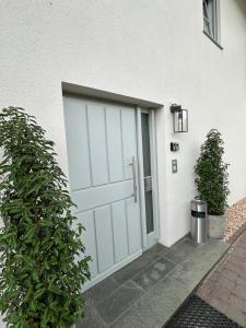 a white garage door on a white house at Living 77 in Fulda