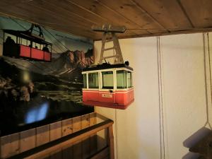 a toy train is hanging from a wall at Casa da Cipi in Venas