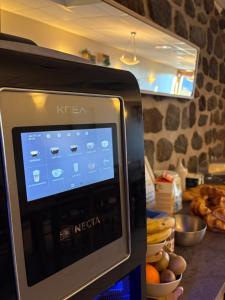 a microwave in a kitchen with some food on a counter at Le Bouffadou in Le Bouchet-Saint-Nicolas +35 photos