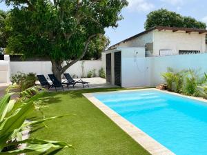 a swimming pool in the yard of a house at Aruba Islander Residence 1 in Oranjestad