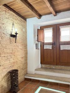 a room with a wooden door and a brick wall at Maruan Heaven in Marvão +80 photos