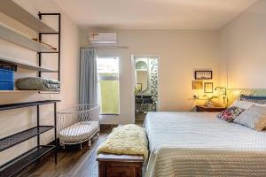 a bedroom with a bed and a chair and a window at RESORT PARTICULAR perfeito p/ famílias com crianças e grupos in Foz do Iguaçu +54 photos