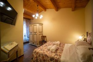 a bedroom with a bed with a stuffed animal on it at Domus Hispellum in Spello +35 photos