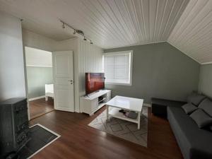 a living room with a couch and a table at KSU Topleiligheten in Kristiansund