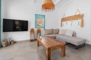 a living room with a couch and a table at Notte di Mare by Tinosstay in Kardhianí +128 photos