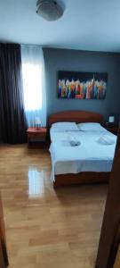 a bedroom with a large bed and a window at GRAND - Beachfront Rooms & Apartments in Selce