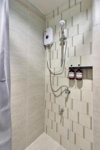 a shower with a shower head in a bathroom at Emily Home-Charming 3BR in Chiang Mai Old Town, Steps from Wat Phra Singh & Sunday Walking Street by Beginning With in Chiang Mai +47 photos