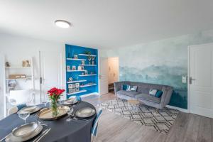 a living room with a table and a couch at Un havre de paix in Thonon-les-Bains +12 photos
