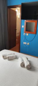 two towels on a bed in a room with a mirror at GRAND - Beachfront Rooms & Apartments in Selce