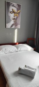 a white bed with a tray on top of it at GRAND - Beachfront Rooms & Apartments in Selce