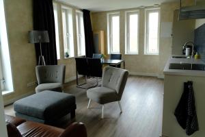 a living room with two chairs and a table at apartment in Uithuizen in Uithuizen