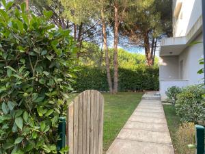 a wooden fence in a yard next to a house at Apartment in Primavera Residence in Fushë-Draç