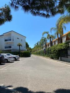 a street with cars parked on the side of the road at Apartment in Primavera Residence in Fushë-Draç