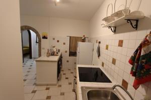 a kitchen with a sink and a refrigerator at Casa Vacanze Il Granaio in SantʼOreste +8 photos