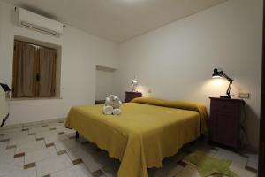 a bedroom with a bed with a teddy bear on it at Casa Vacanze Il Granaio in SantʼOreste