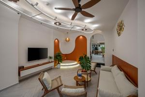 a living room with a couch and a flat screen tv at Shore House - Near My Khe Beach & City Centre by The Key in Da Nang +47 photos
