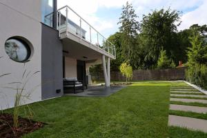 a house with a balcony and a lawn at CASA DEL MAR Apartamenty przy plaży in Pobierowo