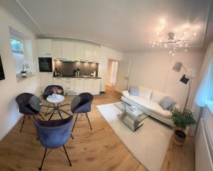 a living room with a couch and a table and chairs at Sandy Coast Apartment Souterrain in Timmendorfer Strand