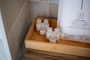 a group of bottles on a wooden shelf in a room at Domus Hispellum in Spello