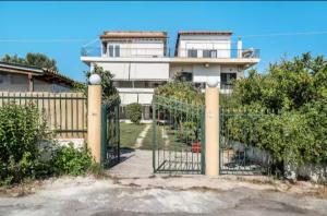a gate in front of a house with a fence at Royal Apartments in Pídima Kyrás +14 photos