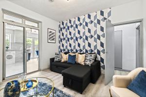 a living room with a couch and a table at Large 5Bed House London Next CUH Free Parking in Mitcham Junction