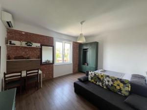 a living room with a couch and a dining room at Balcony 4 bedroom apartment by Book-Rijeka in Rijeka