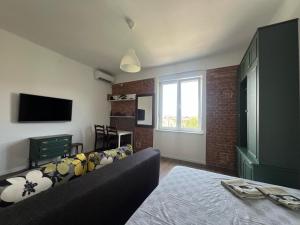 a living room with a couch and a television at Balcony 4 bedroom apartment by Book-Rijeka in Rijeka