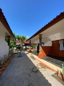 a courtyard of a house with a bed and some plants at Saka Boutique Hotel in Nusa Penida +59 photos
