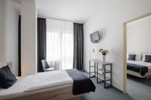 Rúm í herbergi á Hotel Metropol CB