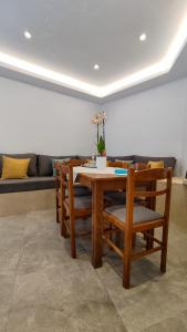 a dining room table with chairs and a couch at Marina's House in Kinídharos
