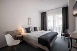 Rúm í herbergi á Hotel Metropol CB