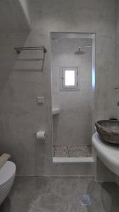 a bathroom with a shower and a toilet and a sink at Marina's House in Kinídharos +12 photos