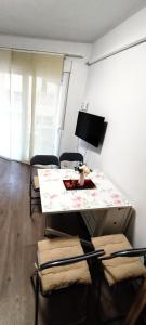 a living room with a table and chairs and a television at Seaview Playa del Cura 50m Torrevieja CityCentre Apartment in Torrevieja