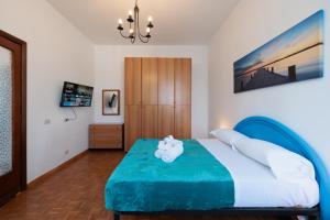 a bedroom with a bed with a teddy bear on it at L'Angolo di Mare in Lido di Ostia
