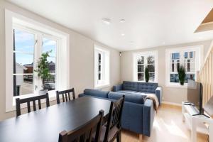 a living room with a table and a couch at Renovated 2025 - AC & terrace - Historic building in Kristiansand