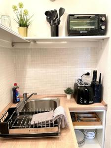a kitchen with a sink and a microwave at Magarethe in Essen