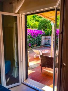 an open sliding glass door of a patio at Appartamento Bellavista in Cavo +7 photos
