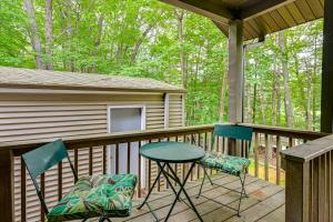 a porch with a table and two chairs on it at Lakefront Home with Private Beach in Rhinelander! in Rhinelander