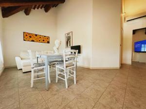 a dining room with a table and chairs and a couch at Baco da Seta in Zelo