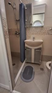 a bathroom with a sink and a shower and a toilet at Villa Detelina Balchik in Balchik +30 photos